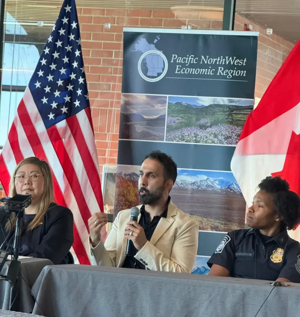 Panel discussion with flags and speakers