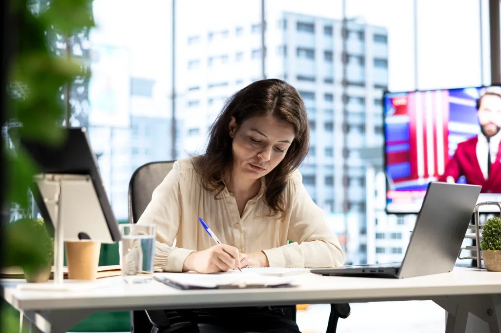 Woman signing documents in office